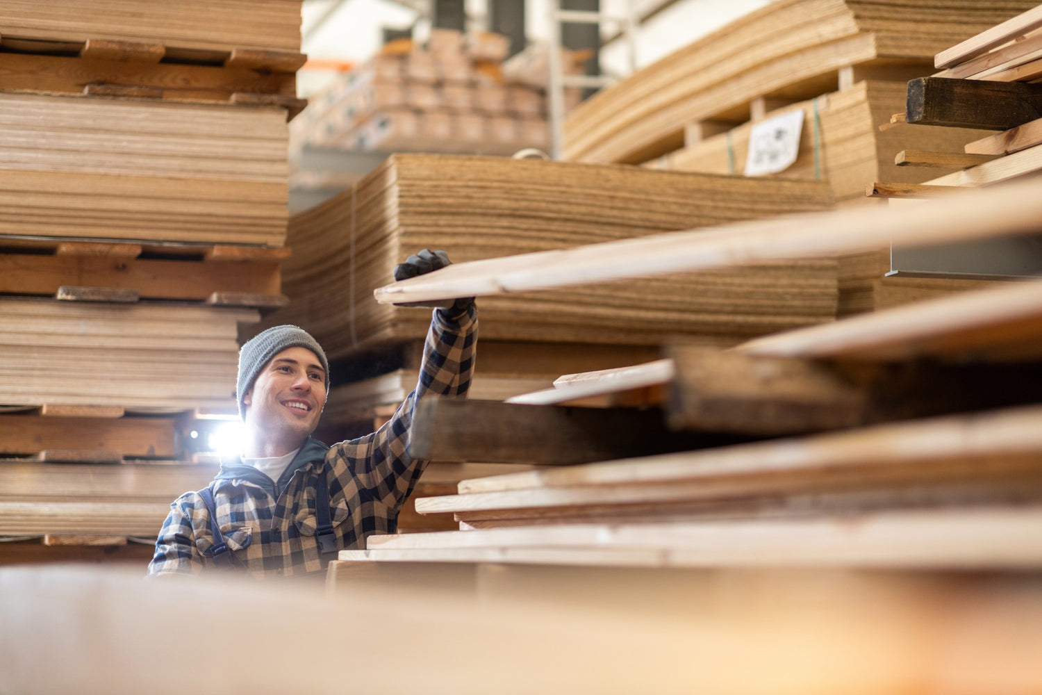 Worker handling a plywood sheet